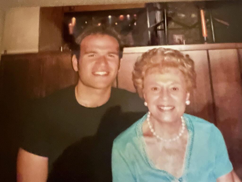 Young Michael Fabiano pictured with his grandmother Maria Fabiano smiling 